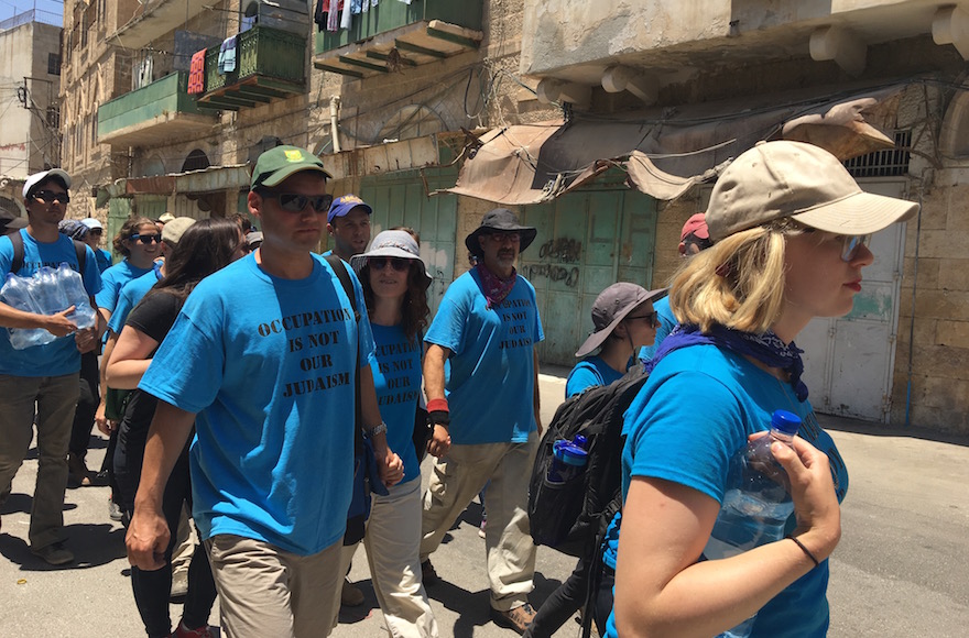 Peter Beinart, left, marching with, with other activists from the Center for Jewish Nonviolence, including, to his right, the movement's CEO, Ilana Sumka, through Hebron, July 16, 2016. (Andrew Tobin)