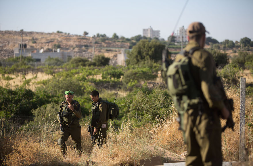 Israeli soldiers guarding the home where Hallel Yaffa Ariel, 13, was stabbed and killed in a terror attack in the Jewish settlement of Kiryat Arba, in the West Bank June 30, 2016. (Yonatan Sindel/Flash90)