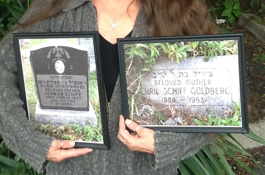 Danette Devlin holding photos of the gravestones of her parents Herman and Cyril Schiff, attesting to her Jewish roots. (Courtesy of Danette Devlin)