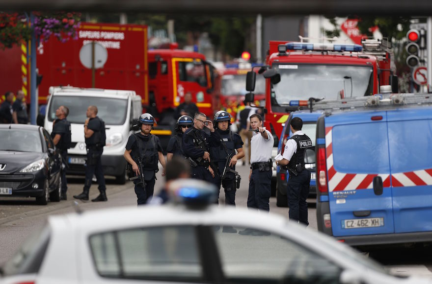 French police officers and fire engine at the scene of a hostage-taking at a church in Saint-Etienne-du-Rouvray, northern France, July 26, 2016. (Charly Triballeau/AFP/Getty Images)