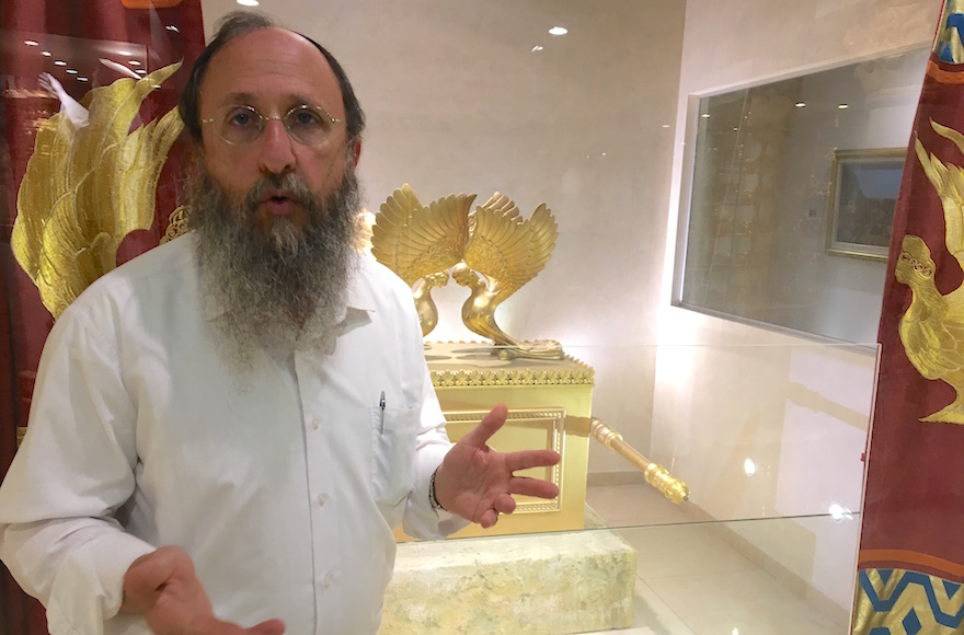 Rabbi Chaim Richman of the Temple Institute standing in front a replica of the ark of the covenant in his group's exhibition in the Old City, Jerusalem, Aug. 11, 2016. (Andrew Tobin)