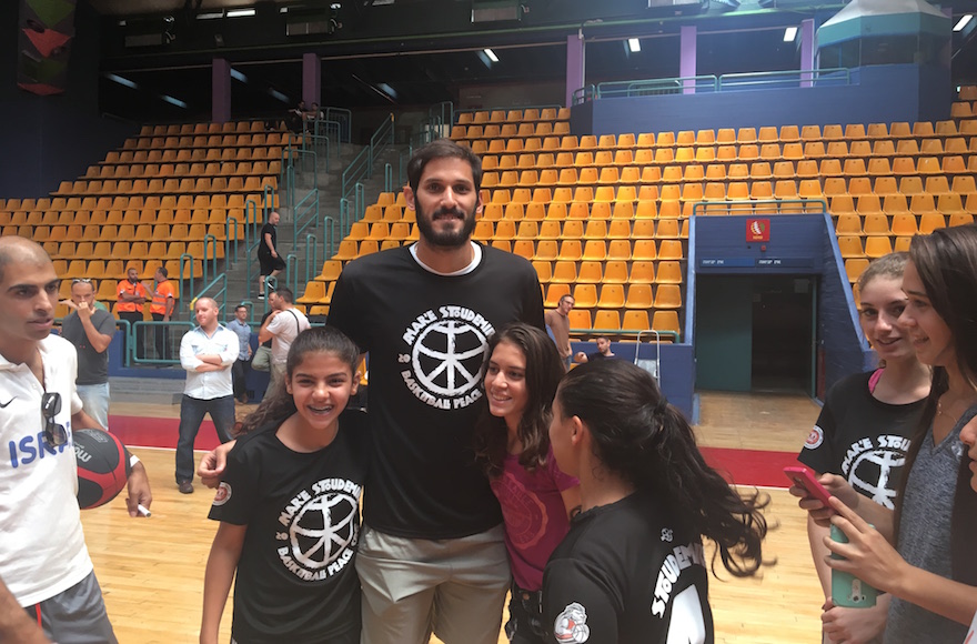 Omri Casspi posing for photos with kids at Amare Stoudemire's basketball camp in Jerusalem, Aug. 8, 2016. (Andrew Tobin)