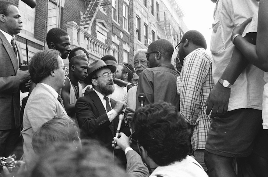 New York City Mayor David Dinkins, fourth from right, looking on while a Hasidic Jew and a black man argue during riots in Crown Heights, Brooklyn in 1991. (Anthony Pescatore/NY Daily News Archive via Getty Images)
