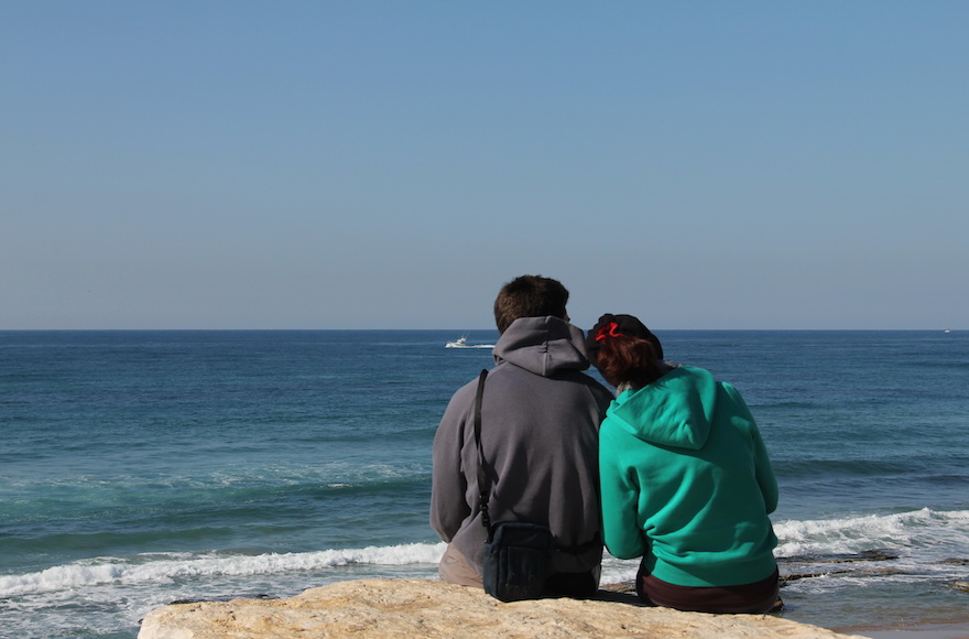 A young couple on the beach in Tel Aviv. (iStock)