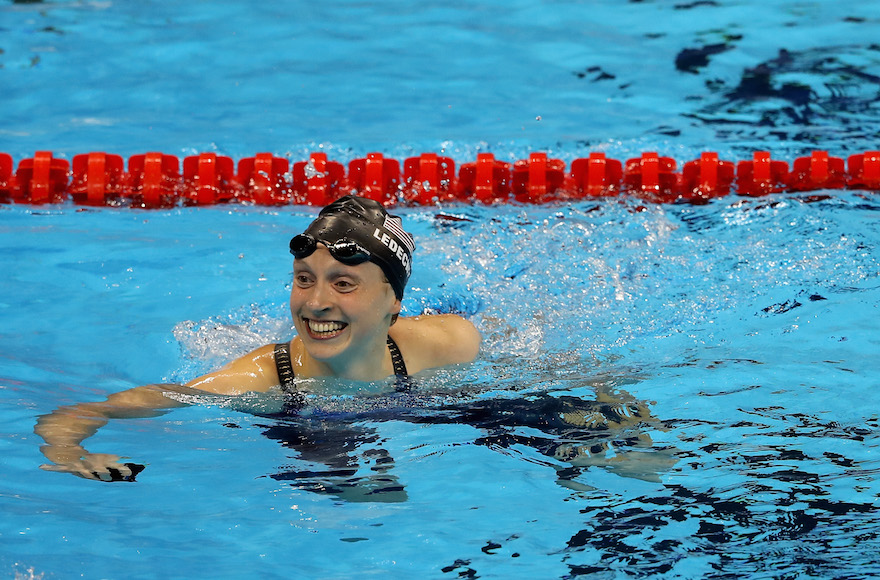 Katie Ledecky celebrating winning gold and setting a new world record in the Women's 400-meter freestyle final on day two of the Rio 2016 Olympic Games at the Olympic Aquatics Stadium, Aug. 7, 2016. (Al Bello/Getty Images)