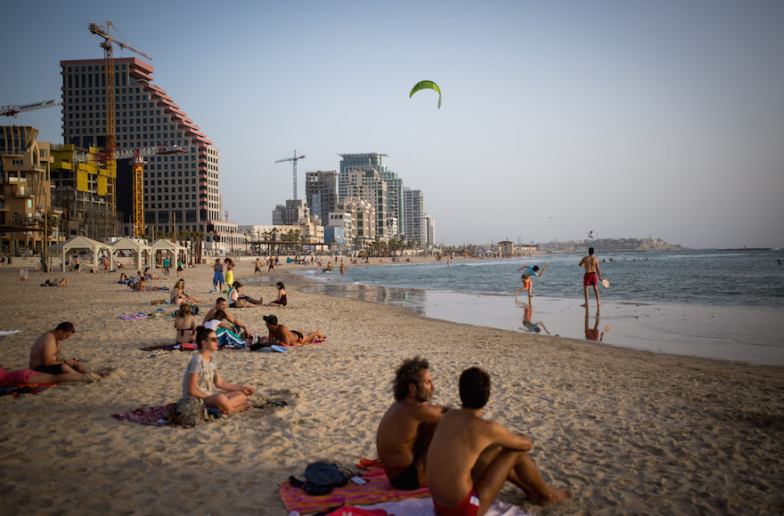 Israelis enjoying the beach in Tel Aviv, May 16, 2016. (Miriam ALster/Flash90)