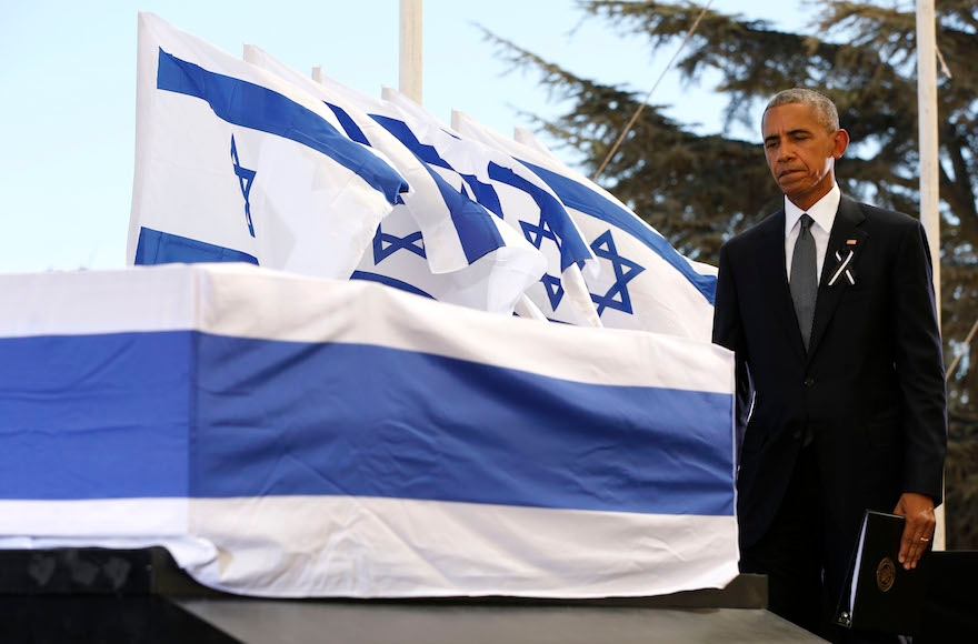 President Barack Obama touching the coffin of Shimon Peres after speaking during his funeral at Jerusalem's Mount Herzl national cemetery, Sept. 30, 2016. (Abir Sultan/AFP/Getty Images)