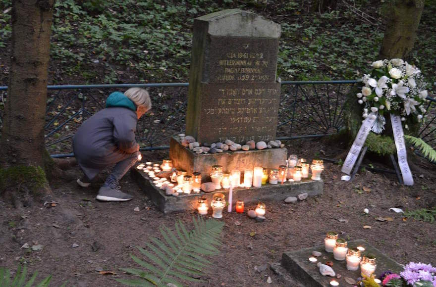 A woman marking the 75th anniversary of the Holocaust on their country’s official Shoah memorial day with a ceremony at Veliucionys, on the outskirts of Vilna, one of the most neglected of the 227 mass graves of Holocaust victims in Lithuania, Sept. 23, 2016. (Courtesy Efraim Zurkoff) 