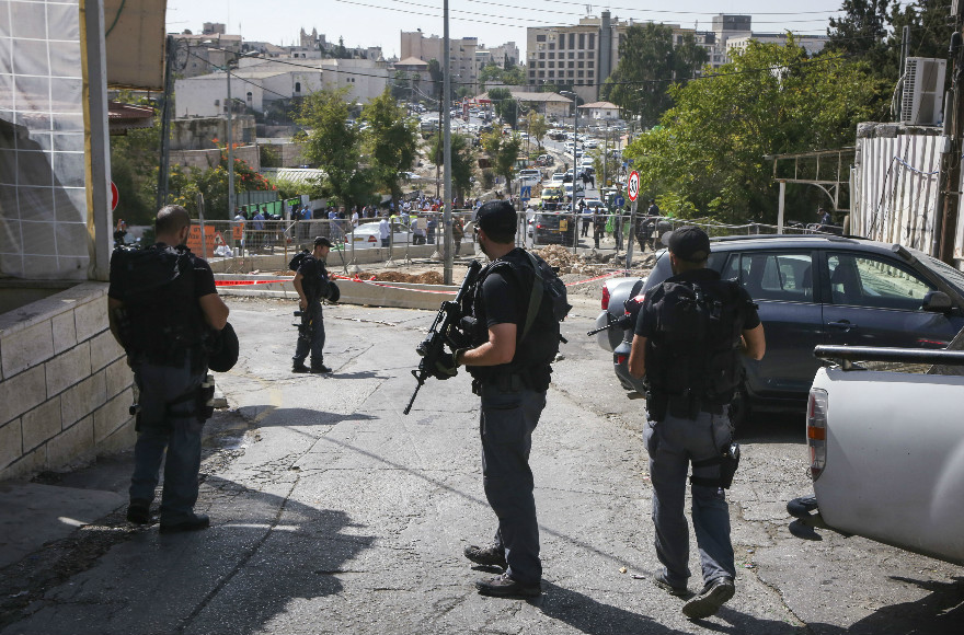 Israeli security officers in the eastern Jerusalem neighborhood of Sheikh Jarrah after police shot and killed a Palestinian shooter who killed 2 and injured at least 6 others in an attack on a Jerusalem light rail station on October 9, 2016. (Shlomi Cohen/Flash90)