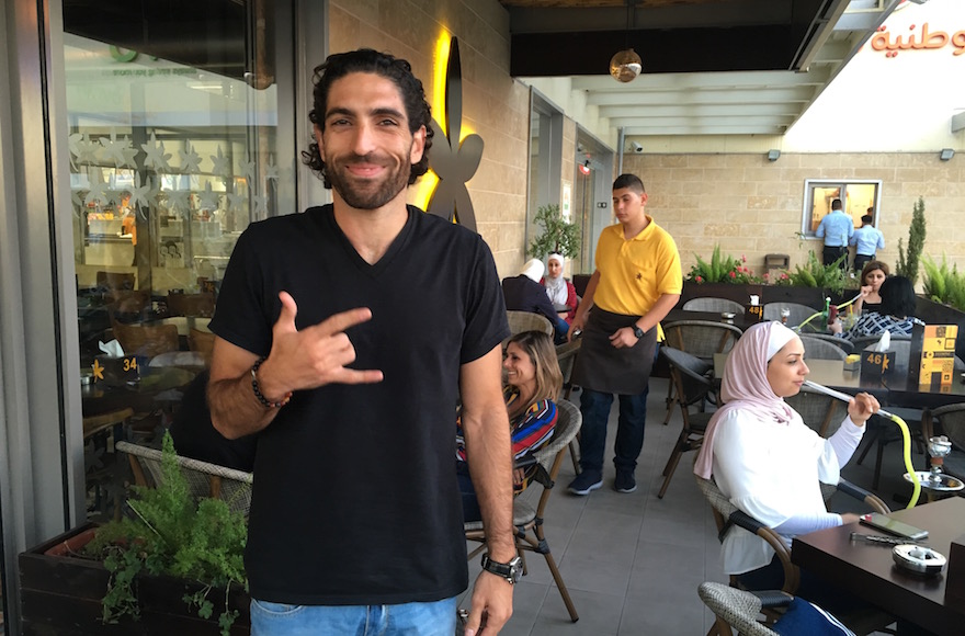 Owner John Saadeh standing outside Jasmine Cafe in Nablus, West Bank, Sept. 18, 2016. (Andrew Tobin)