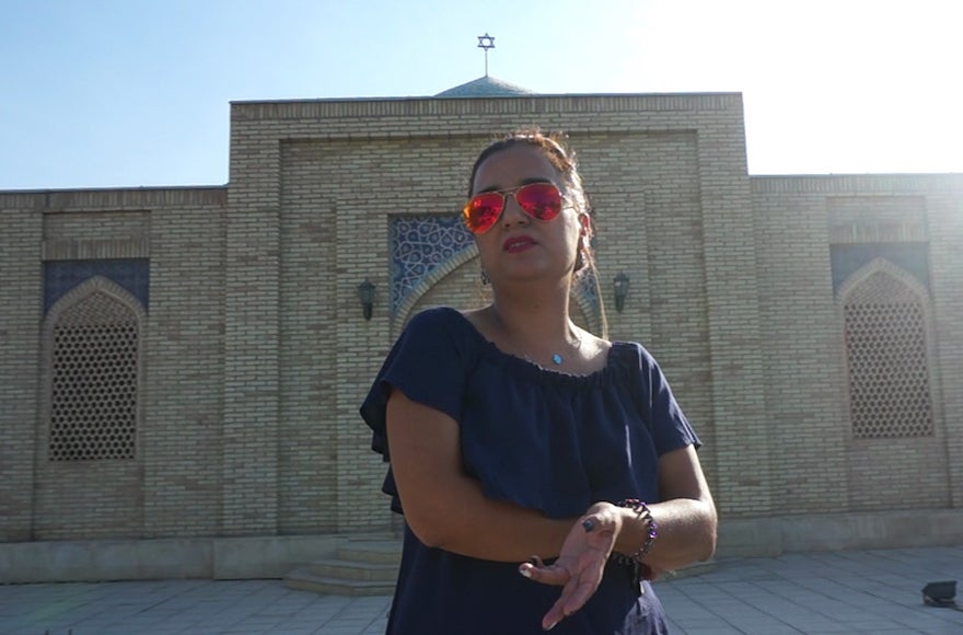 Shirin Yakubov standing in front of Bukhara's Jewish cemetery, Sept. 9, 2016. (Cnaan Liphshiz)