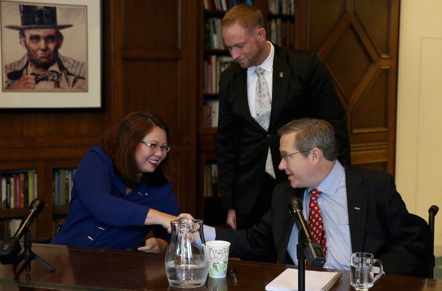 Tammy Duckworth, left, and Mark Kirk , front right, shaking hands after their debate in the Chicago Tribune Editorial Board room, Oct. 3, 3016. (Nancy Stone/Chicago Tribune/TNS via Getty Images)