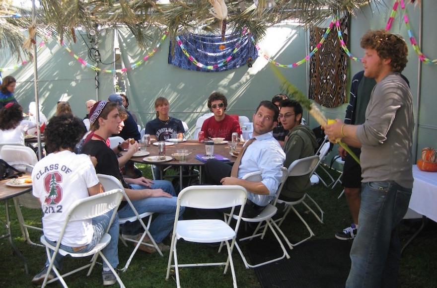 Stanford University Hillel students enjoying a meal in their sukkah, Oct. 2009. (Stanford University Hillel)