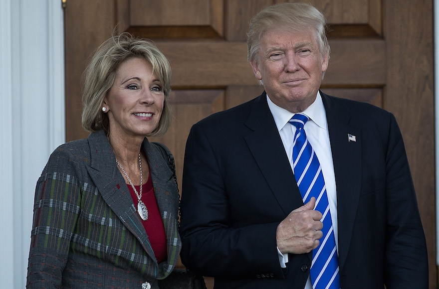 Betsy DeVos and president-elect Donald Trump outside the clubhouse at Trump International Golf Club, in Bedminster Township, N.J., Nov. 19, 2016 (Drew Angerer/Getty Images)