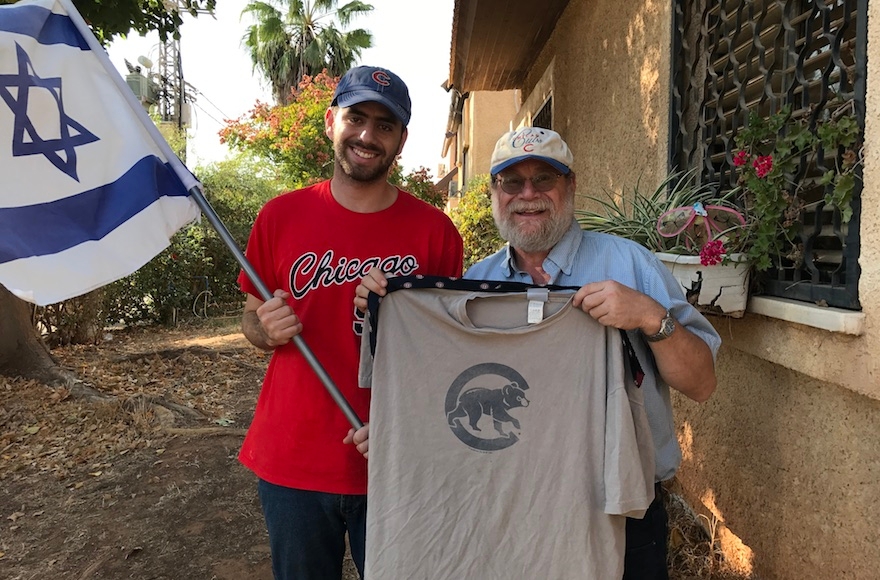 Harel Gold (left) and Rabbi Sidney Gold displaying their Cubs gear outside their home in Karnei Shomron in the West Bank, Oct. 28, 2016. (Andrew Tobin)