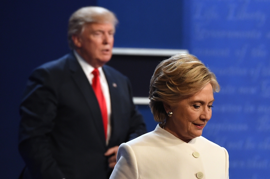 TOPSHOT - Democratic nominee Hillary Clinton (R) and Republican nominee Donald Trump walk off the stage after the final presidential debate at the Thomas & Mack Center on the campus of the University of Las Vegas in Las Vegas, Nevada on October 19, 2016. / AFP / Robyn Beck (Photo credit should read ROBYN BECK/AFP/Getty Images)