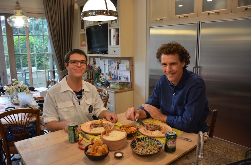 Danny Ashkenazi, left, and Tom Franz preparing to eat filet Osvaldo Aranha in Jerusalem, Nov. 2016. (Courtesy of World Bnei Akiva)