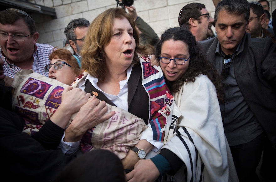 Orthodox Jews trying to prevent a group of Conservative and Reform rabbis and Women of the Wall members from bringing Torah scrolls into the Western Wall compound in Jerusalem Old City, Nov. 2, 2016. (Hadas Parush/Flash90