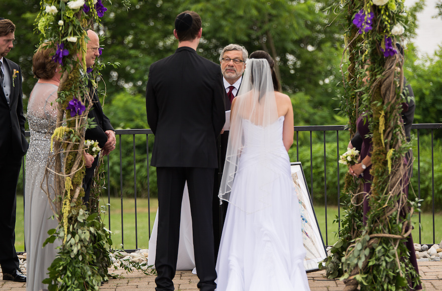 Rabbi Seymour Rosenbloom officiating at the wedding of his stepdaughter and her fiance in 2014. (Courtesy of Stefanie Fox)