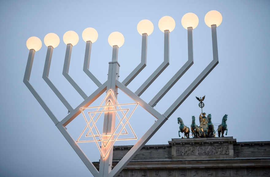 A giant candelabrum Menorah being lit in front of Brandenburg Gate to commemorate the victims, among them Israeli woman Dalia Elyakim, of the truck attack at the Christmas Market, in Berlin, Germany, Dec. 22, 2016 in Berlin. Clemens Bilan/AFP/Getty Images)