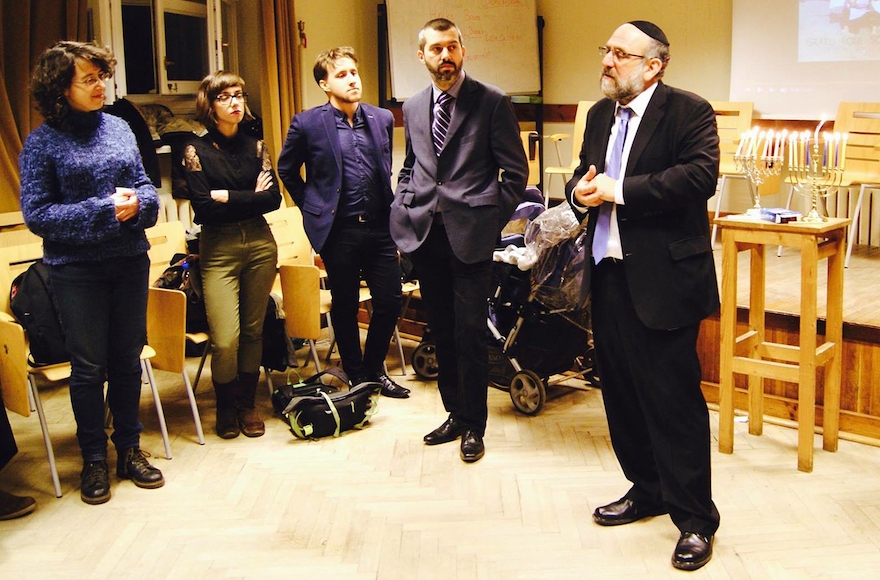 Rabbi Michael Schudrich, right, speaking to students attending the Judaic Department Hanukkah event at the University of Warsaw on Dec. 20, 2016. (Courtesy of Michael Schudrich)