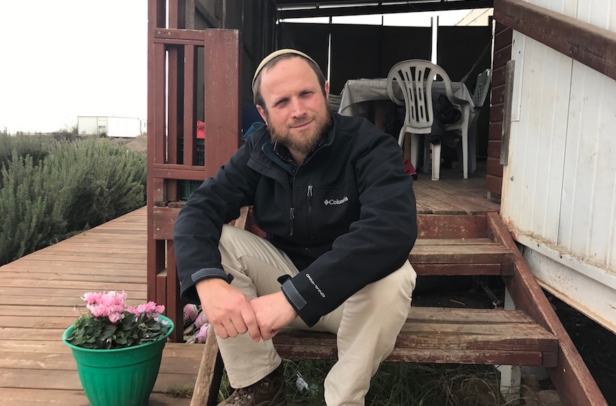 Eli Greenburg sitting outside his home in Amona, the West Bank, Dec. 13, 2016. (Andrew Tobin)