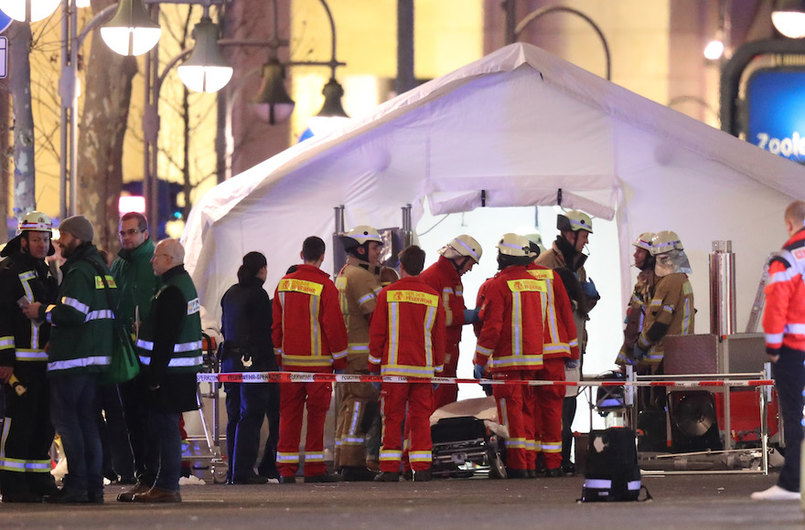 Rescue workers outside a tent in the area after a lorry truck ploughed through a Christmas market in Berlin, Dec. 19, 2016. (Sean Gallup/Getty Images)