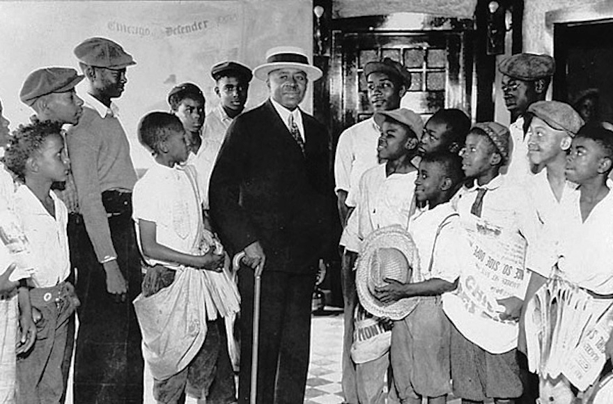 Chicago Defender Founder and Publisher Robert S. Abbott surrounded by newsboys in an undated photo from the 1920s. (Courtesy of the Chicago Defender Charities) 