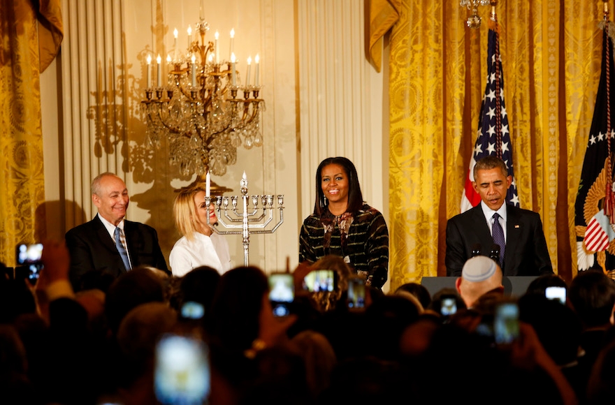 President Barack Obama and First Lady Michelle Obama attending the second Hanukkah reception of the day with the grand-daughter and son of late Israeli statesman Shimon Perez, Mika Almog, far left, and Chemi Perez, center left, in the East Room of the White House in Washington, Dec. 14, 2016. (Aude Guerrucci-pool/Getty Images)