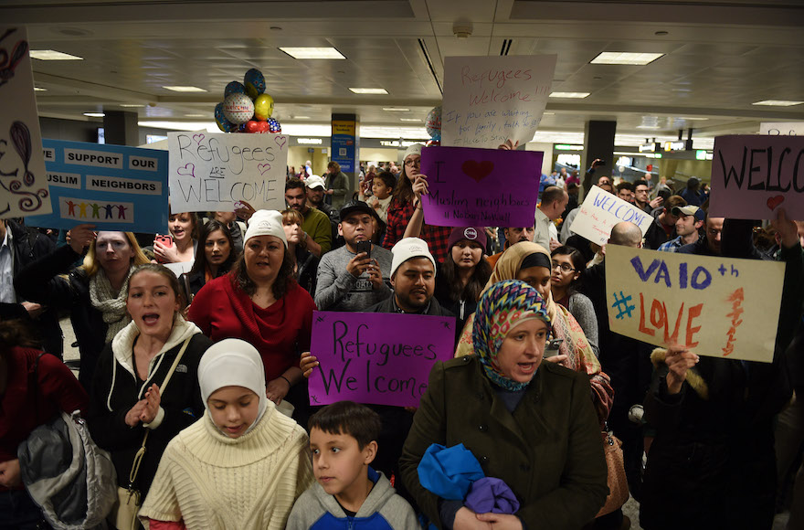 People protesting and welcoming arriving passengers at Dulles International Airport in Virginia, Jan. 28, 2017. (Astrid Riecken for The Washington Post via Getty Images)