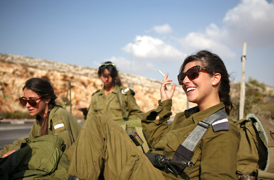 Israeli soldiers waiting for a bus near Ramallah, in the West Bank, Oct. 1, 2009. (Matanya Tausig/Flash 90)