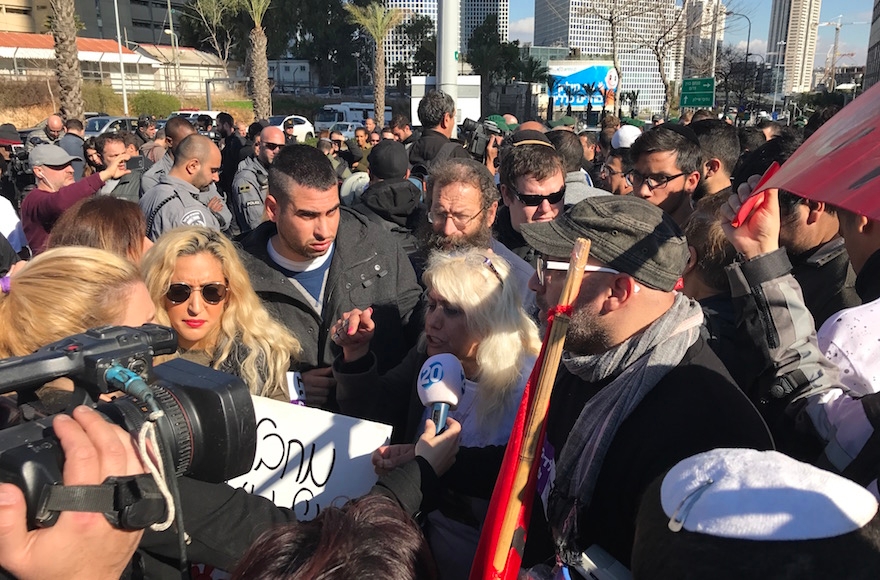 Protestors speaking to the media at a rally for Elor Azaria, an Israeli soldier convicted for killing a subdued Palestinian attacker, in Tel Aviv, Jan. 4, 2016. (Andrew Tobin)