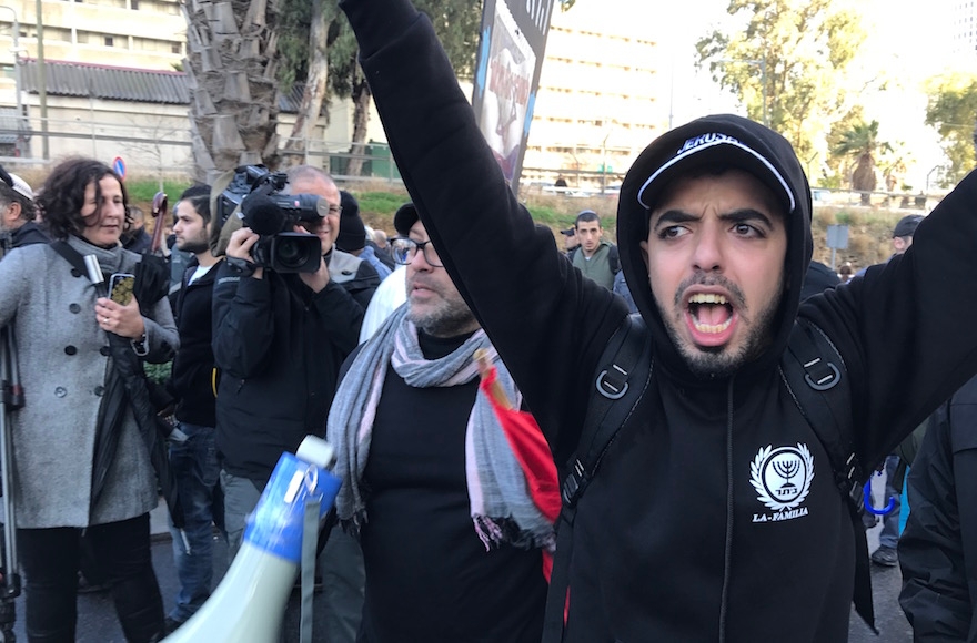 Protestors at a rally for Elor Azaria being forced off the street by police, in Tel Aviv, Jan. 4, 2016. (Andrew Tobin)