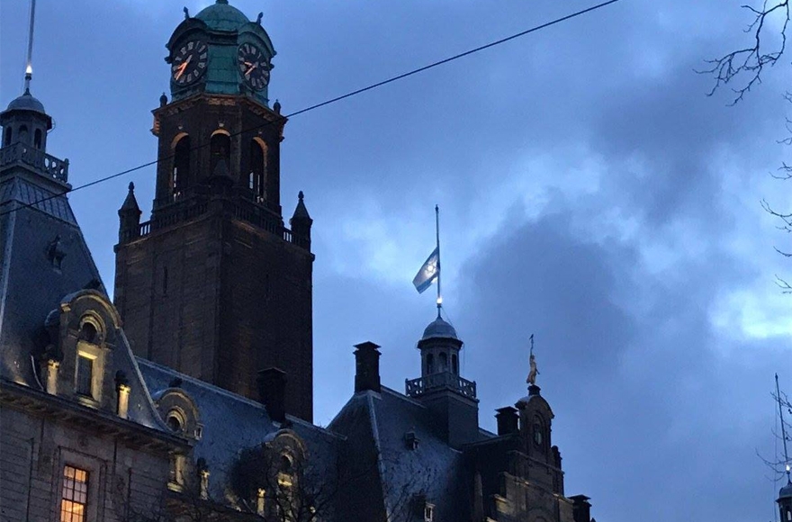 The Israeli flag flying at half-mast atop City Hall in rotterdam, the Netherlands, on Jan. 10, 2017. (Photo courtesy of NIW/David de Leeuw)