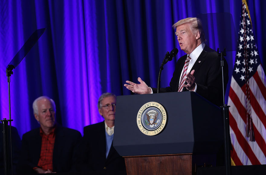 President Donald Trump speaking as Senate Majority Leader Sen. Mitch McConnell, center, and Senate Majority Whip Sen. John Cornyn, left, look on during a luncheon at the Congress of Tomorrow Republican Member Retreat in Philadelphia, Jan. 26, 2017. (Alex Wong/Getty Images)