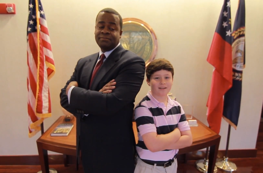 Atlanta Mayor Kasim Reed striking a pose with Daniel Blumen for Blumen's viral "Save the Date" bar mitzvah video. (YouTube) 