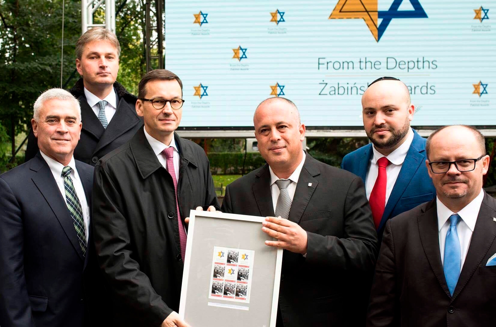 Mateusz Morawiecki. 3rd from left, holding a document honoring rescuers of Jews at Warsaw Zoo on Sept, 18, 2017. Courtesy of From the Depths