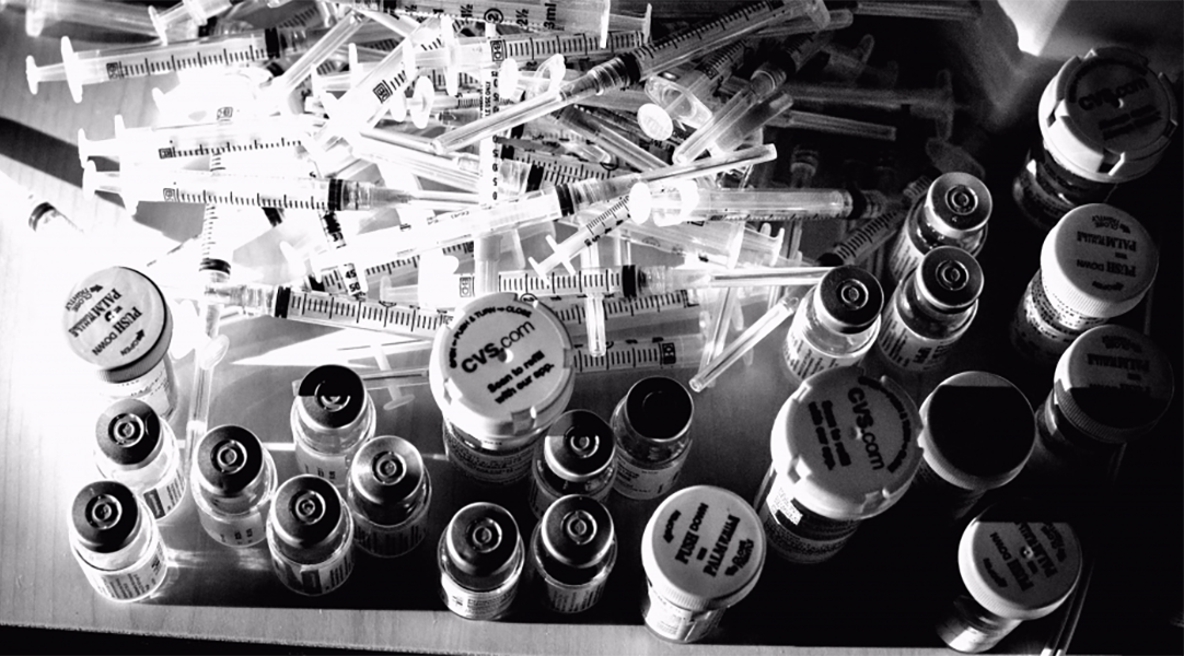 Pill bottles and needles.