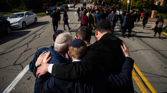 Mourners embrace during a processional outside of Congregation Beth Shalom in Pittsburgh for the funeral of Joyce Fienberg, who was killed at the mass shooting at the Tree of Life synagogue shooting, Oct. 31, 2018. (Salwan Georges/The Washington Post via Getty Images)