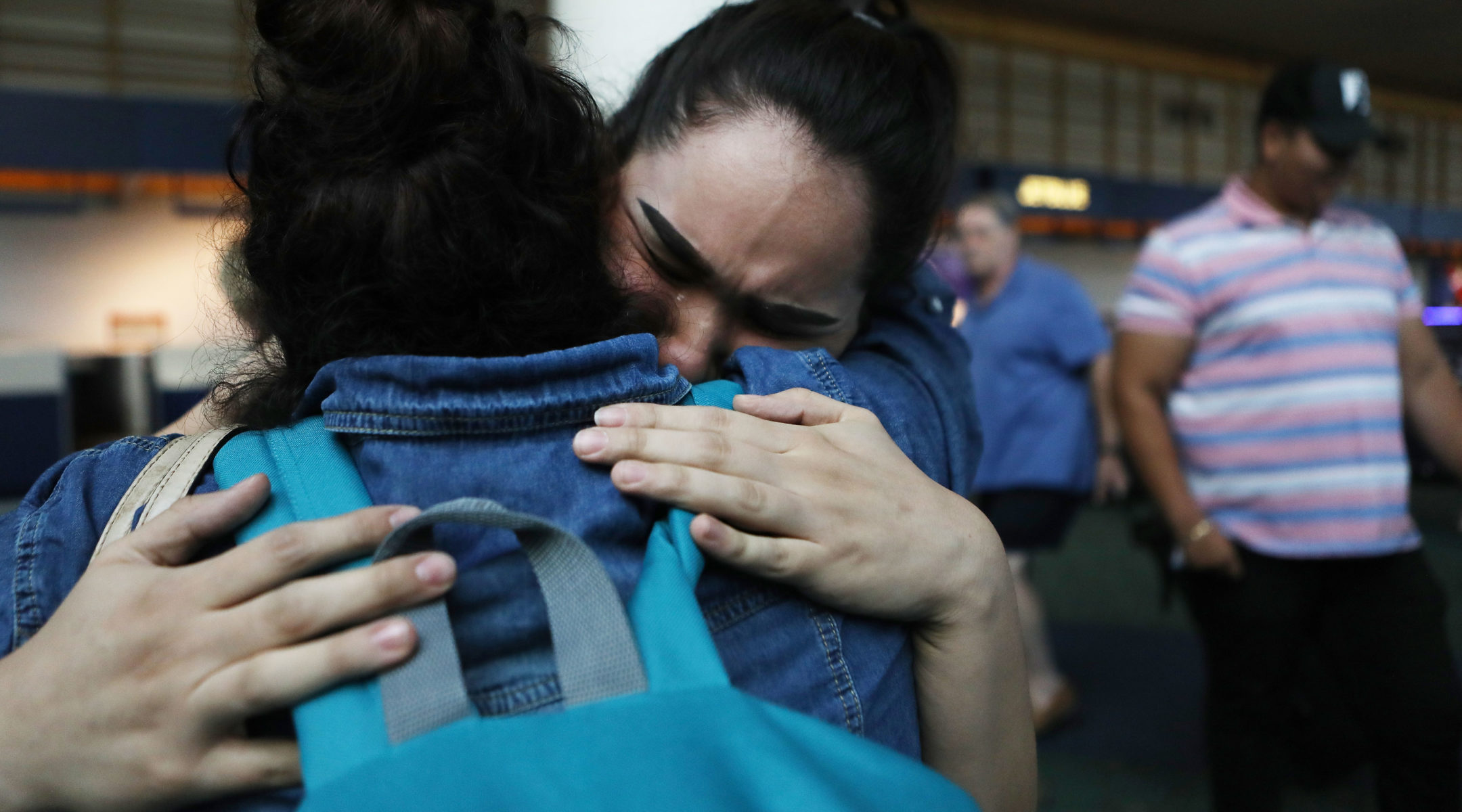 An immigrant recently released after spending six months in an ICE detention facility, is hugged by her daughter while being reunited with family at Portland International Airport on September 2, 2018. (Mario Tama/Getty Images)