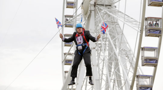 British Prime Minister-elect Boris Johnson waiting to glide on a zip line onto the Olympic Park in London, the United Kingdom, on August 1, 2012. (Barcroft Media / Barcroft Media via Getty Images)