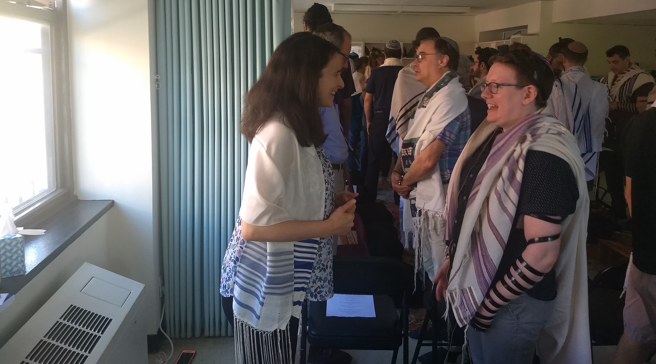 Sarah Hurwitz (left), a former speechwriter for First Lady Michelle Obama, does a "gazing exercise" with rabbinical student Lily Solochek at Romemu Yeshiva in New York, N.Y. on July 16, 2019. (Ben Sales)