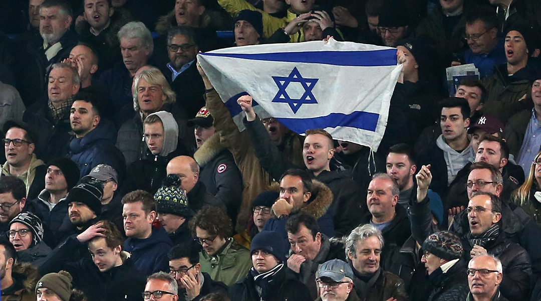 Soccer supporters hold an Israeli flag during a match between Chelsea and Tottenham Hotspur at in London, the United Kingdom on Jan. 24, 2019. (Charlotte Wilson/Offside/Getty Images)