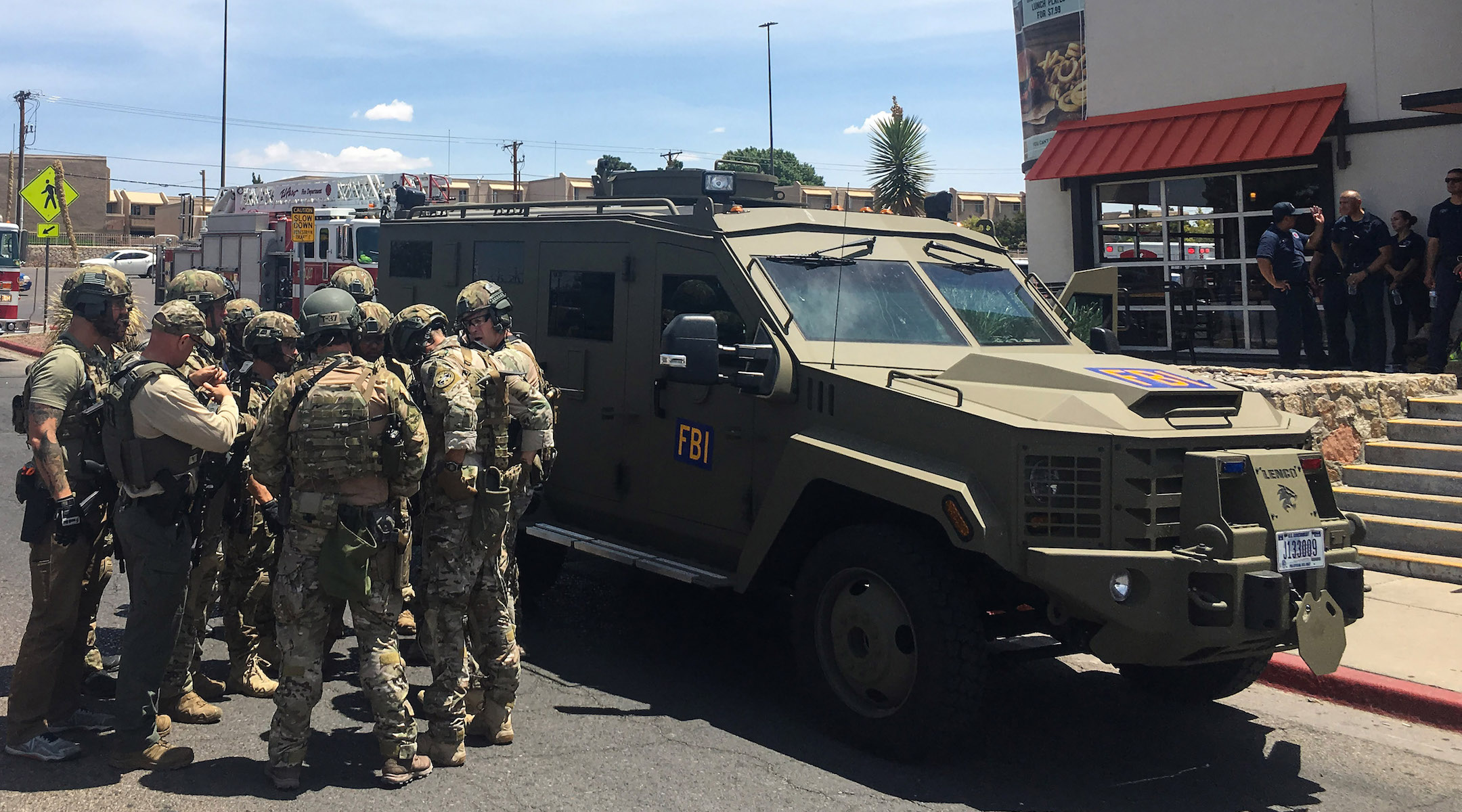 Armed policemen gather next to an FBI armored vehicle next to the Cielo Vista Mall in El Paso on August 3, 2019. The shooter is being investigated as a domestic terrorist. (Joel Angel Juarez/AFP/Getty Images)