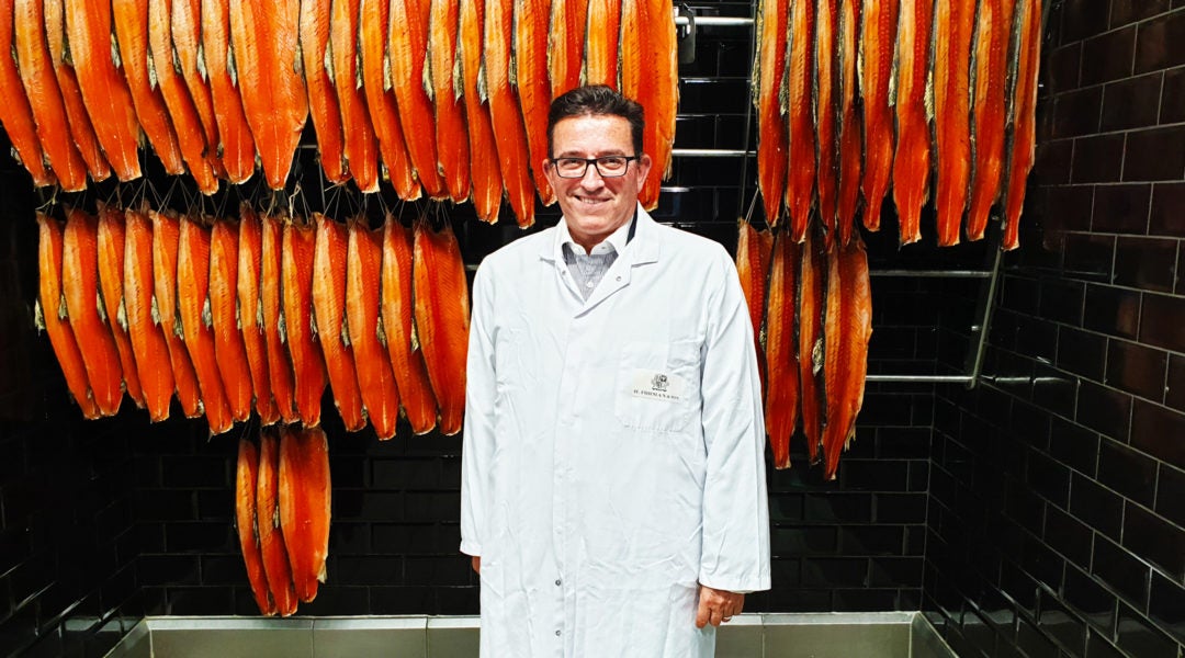 Lance Forman showing off the final product of his smoked salmon factory in the East End of London, the United Kingdom on Sept. 4, 2019 (Cnaan Liphshiz)