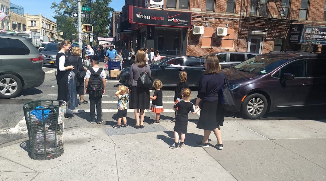 Women and children wait at a crosswalk in the Orthodox neighborhood of Borough Park, Brooklyn on Tuesday, September 3. (Ben Sales)