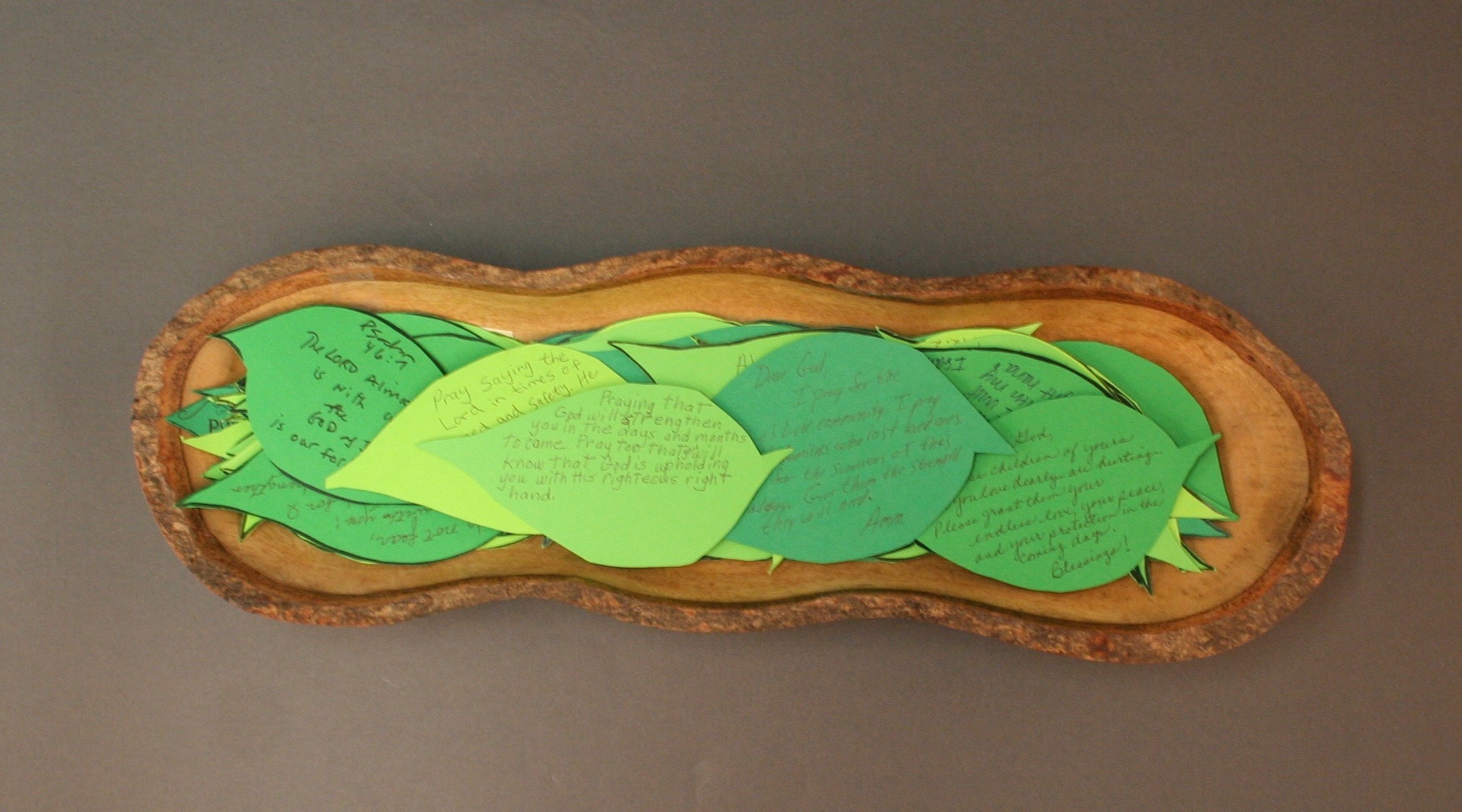 A wooden bowl holding notes of condolence shaped like leaves, sent by a church in Pittsburgh following the synagogue shooting. (Courtesy of the Rauh Jewish Archive)