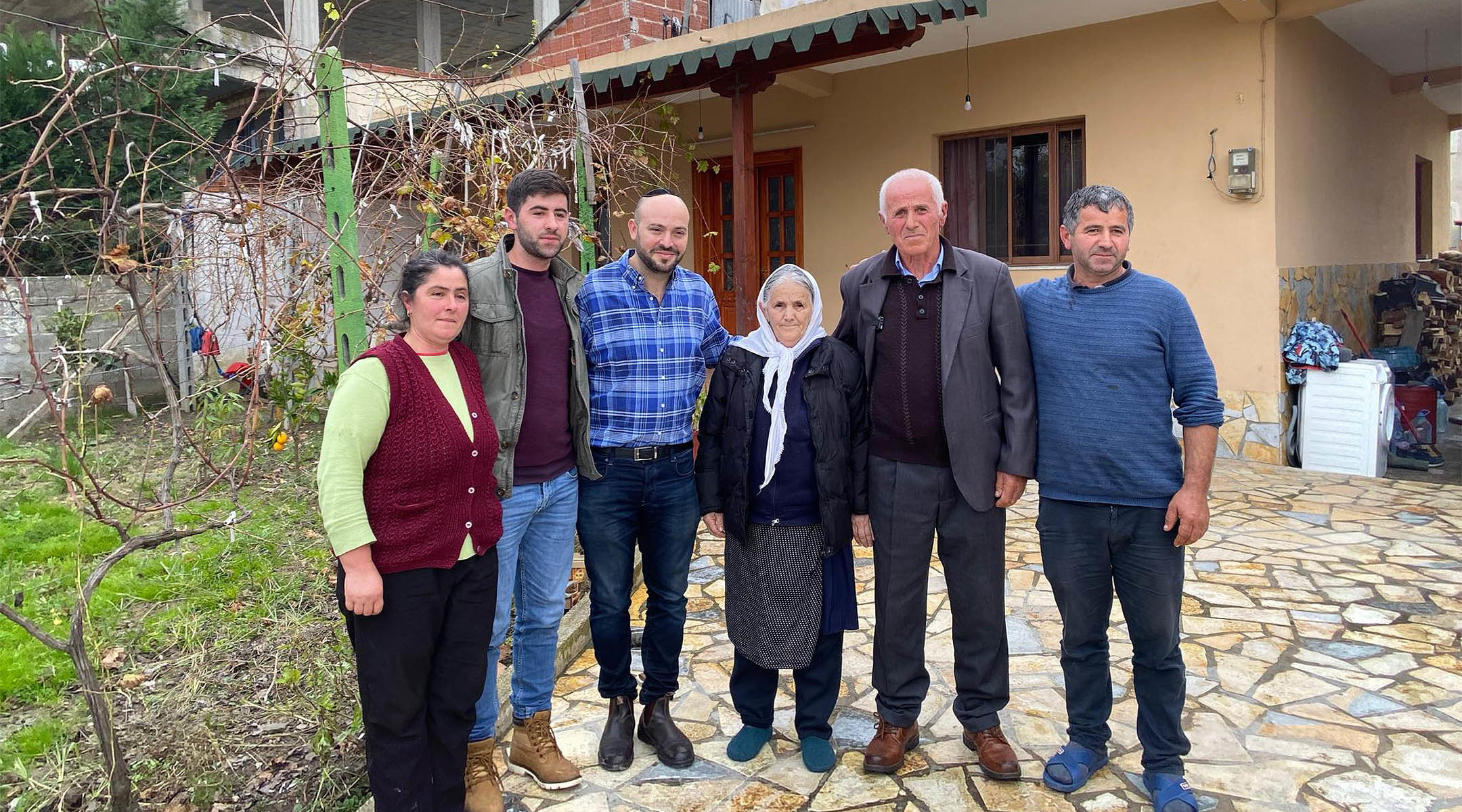 Jonny Daniels, third from left, with the Bicaku family in their home in Durres, Albania on Dec. 11, 2019. (Courtesy of From the Depths)