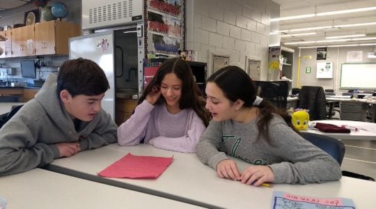 Students in an 8th grade Hebrew class at Alan B. Shepard Middle School in Deerfield, Ill. write a Hebrew screenplay together on Dec. 13. (Ben Sales)