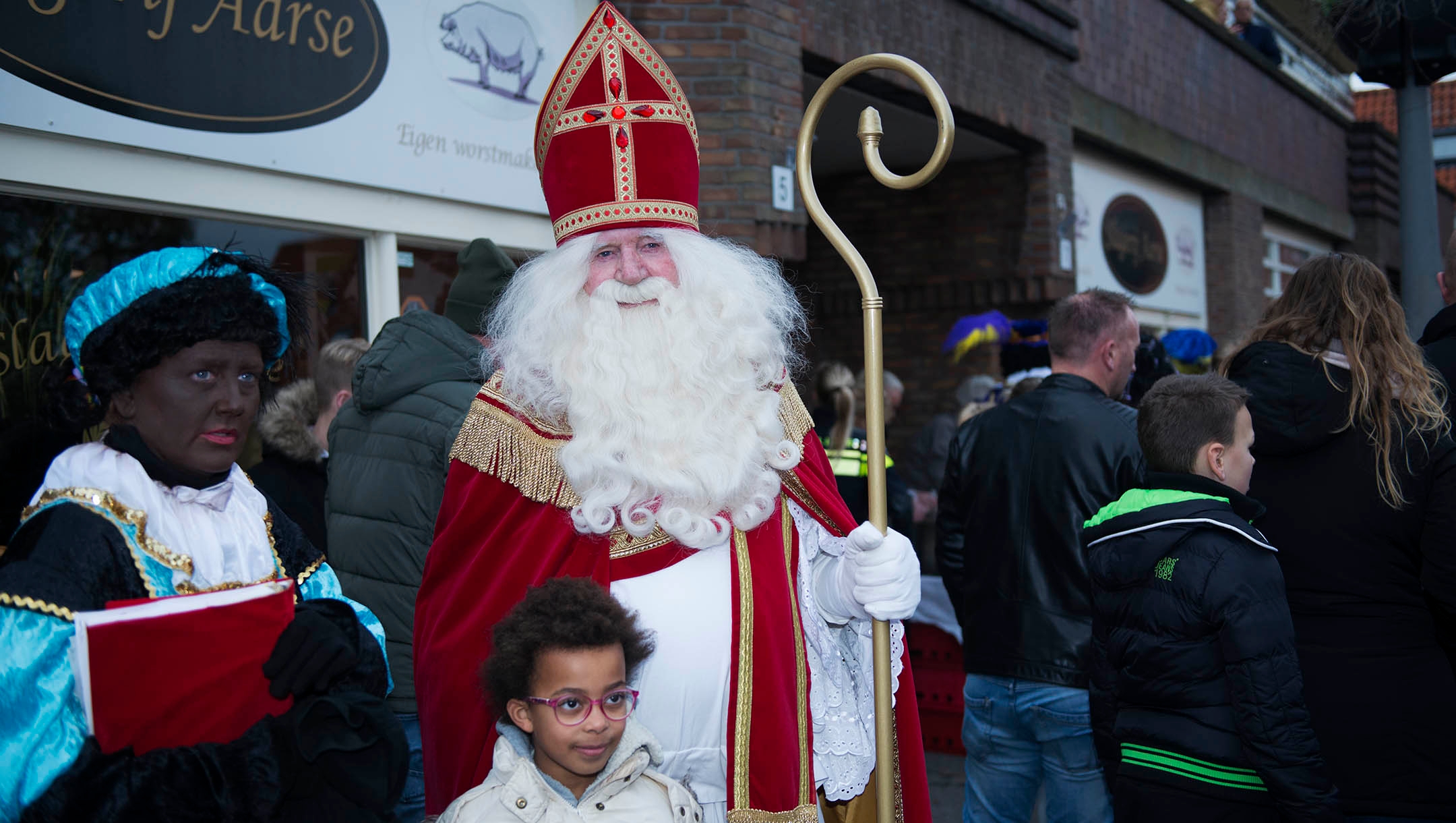 A man dressed like Sinterklaas and a woman portraying Black Pete entertaining children under police protection in northern Amsterdam, the Netherlands on Nov. 16, 2019. (Cnaan Liphshiz)